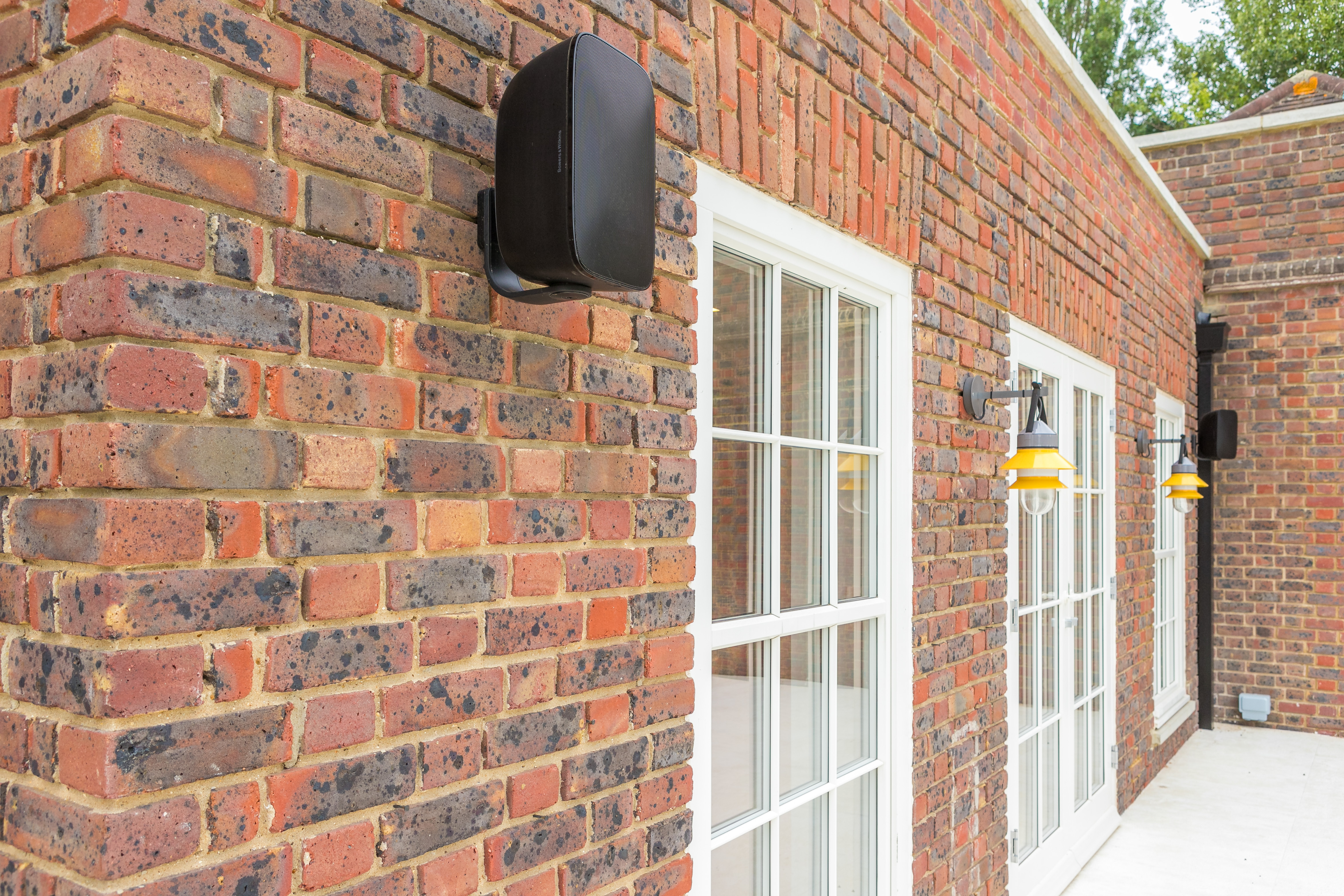 Exterior speakers, quirky wall lights, limestone floor slabs and architectural Georgian wooden window frames