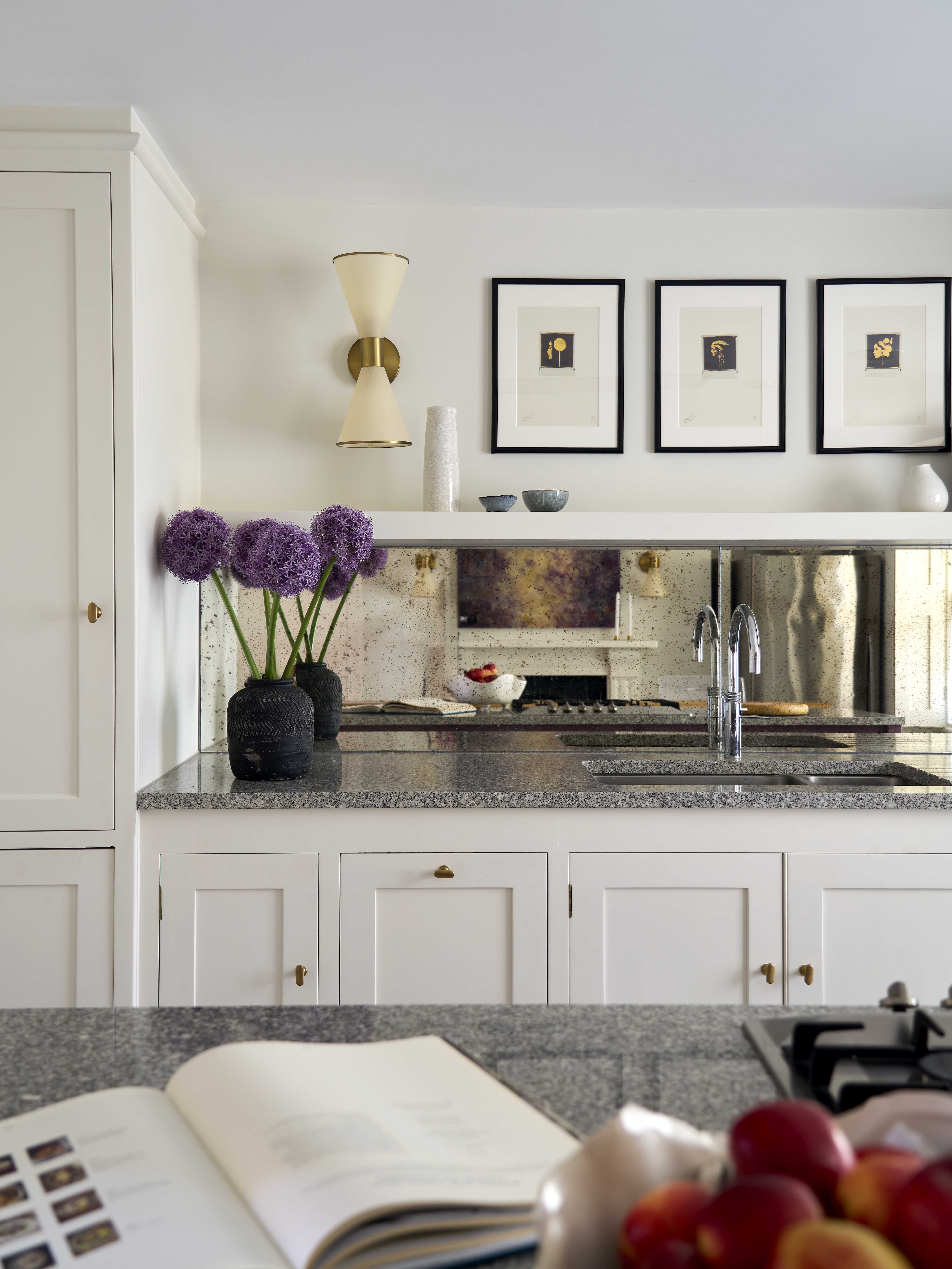 We refinished our clients existing kitchen from black to a warm white, again incorporating antique mirror to bring light and movement
