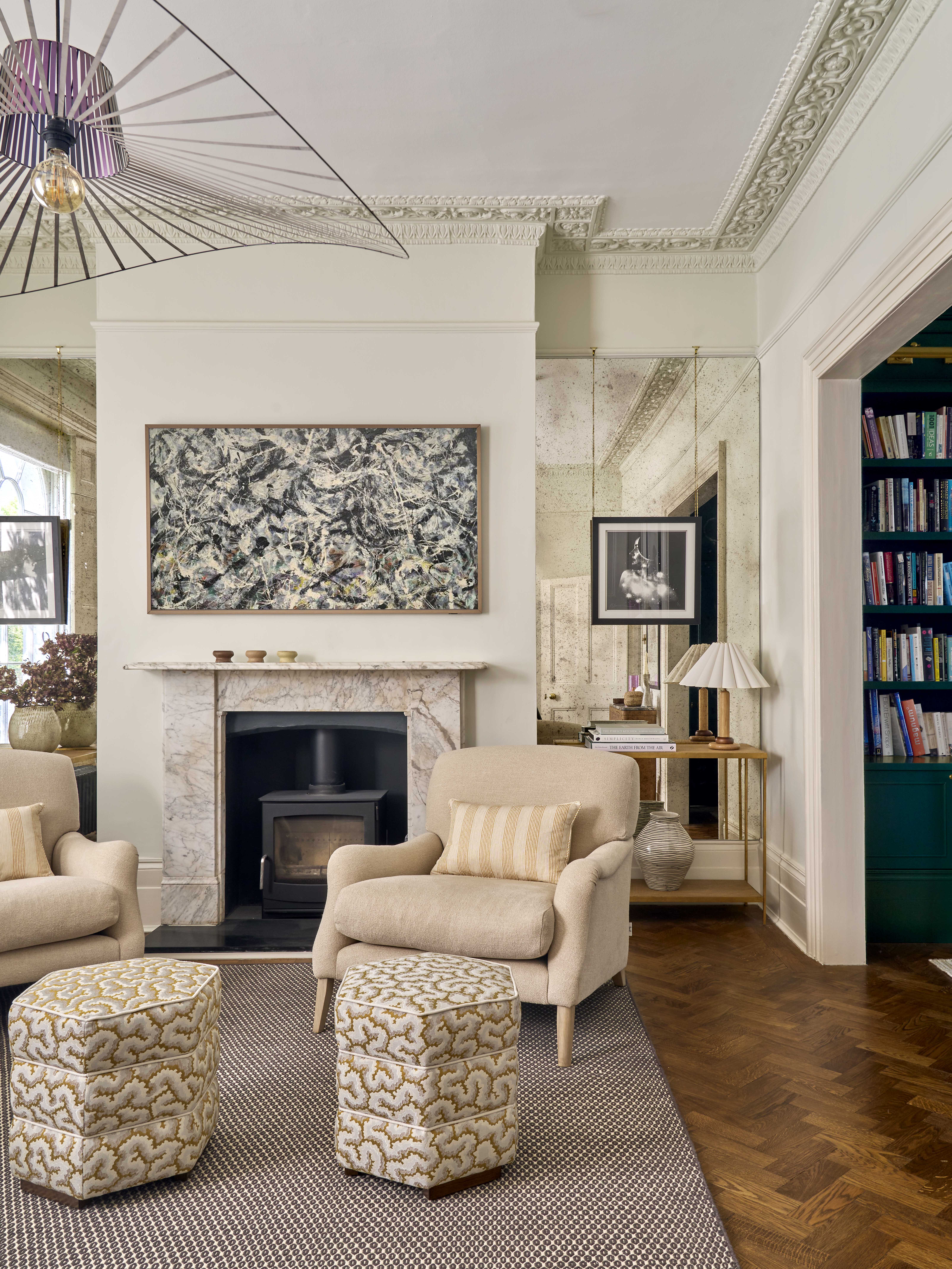 In the alcoves around the fireplace, we incorporated full height antique mirrors to bring movement and light into the space