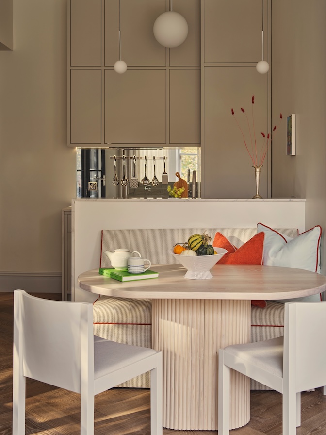 Small galley kitchen and dining area with upper cabinetry to the ceiling for maximum storage solutions