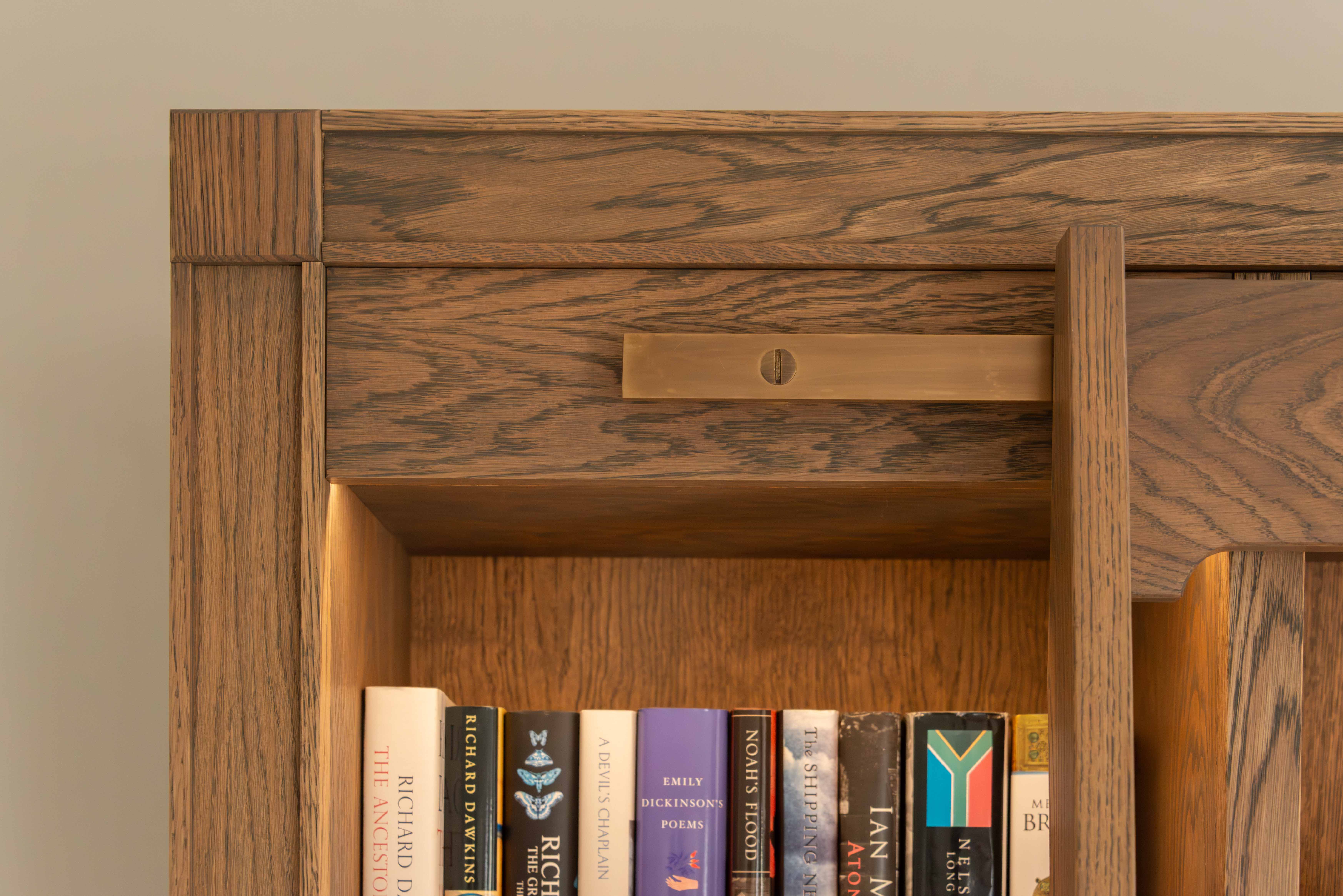 Bookcase detail with library ladder and brass rail