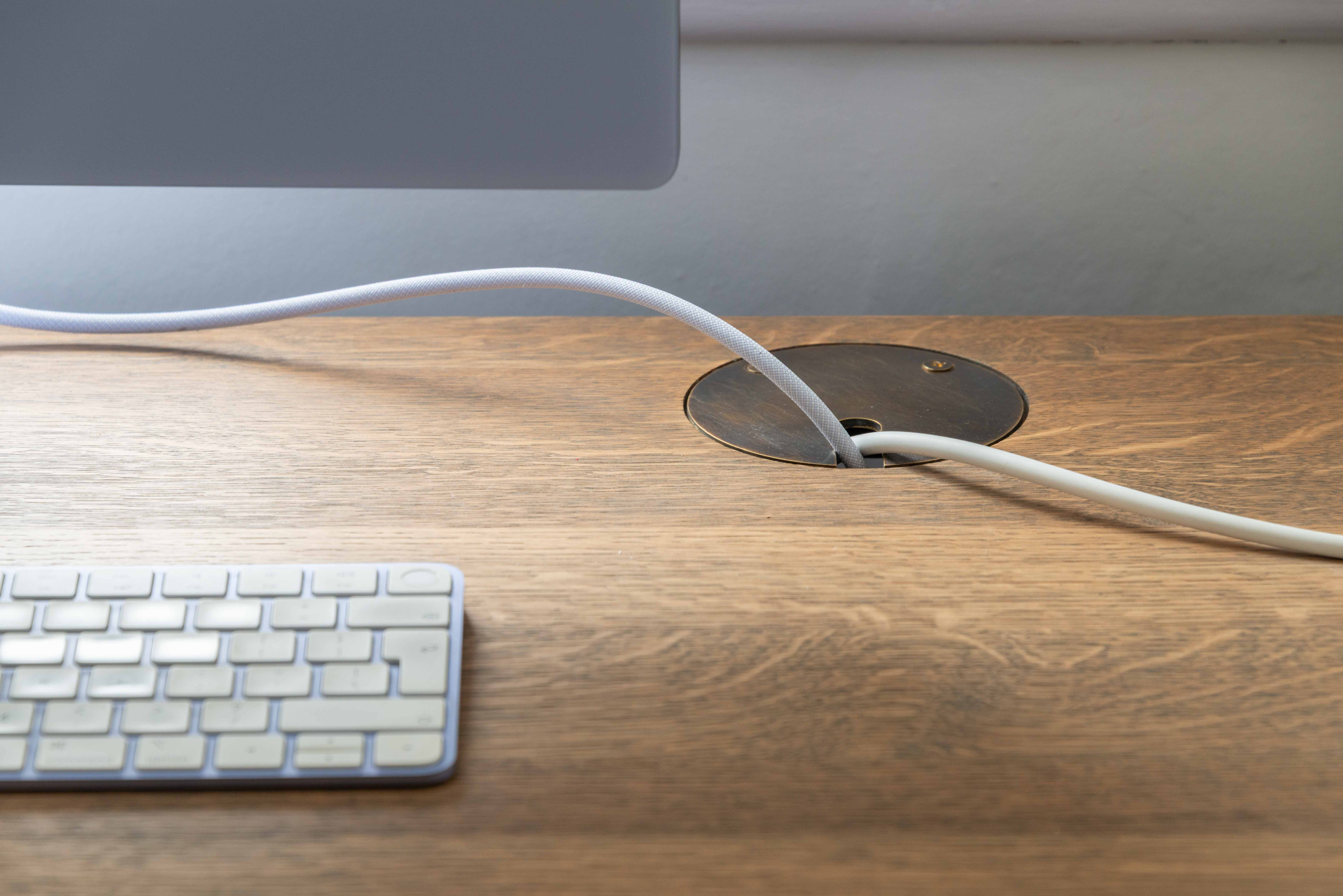 Desk detail with bespoke brass cable grommet