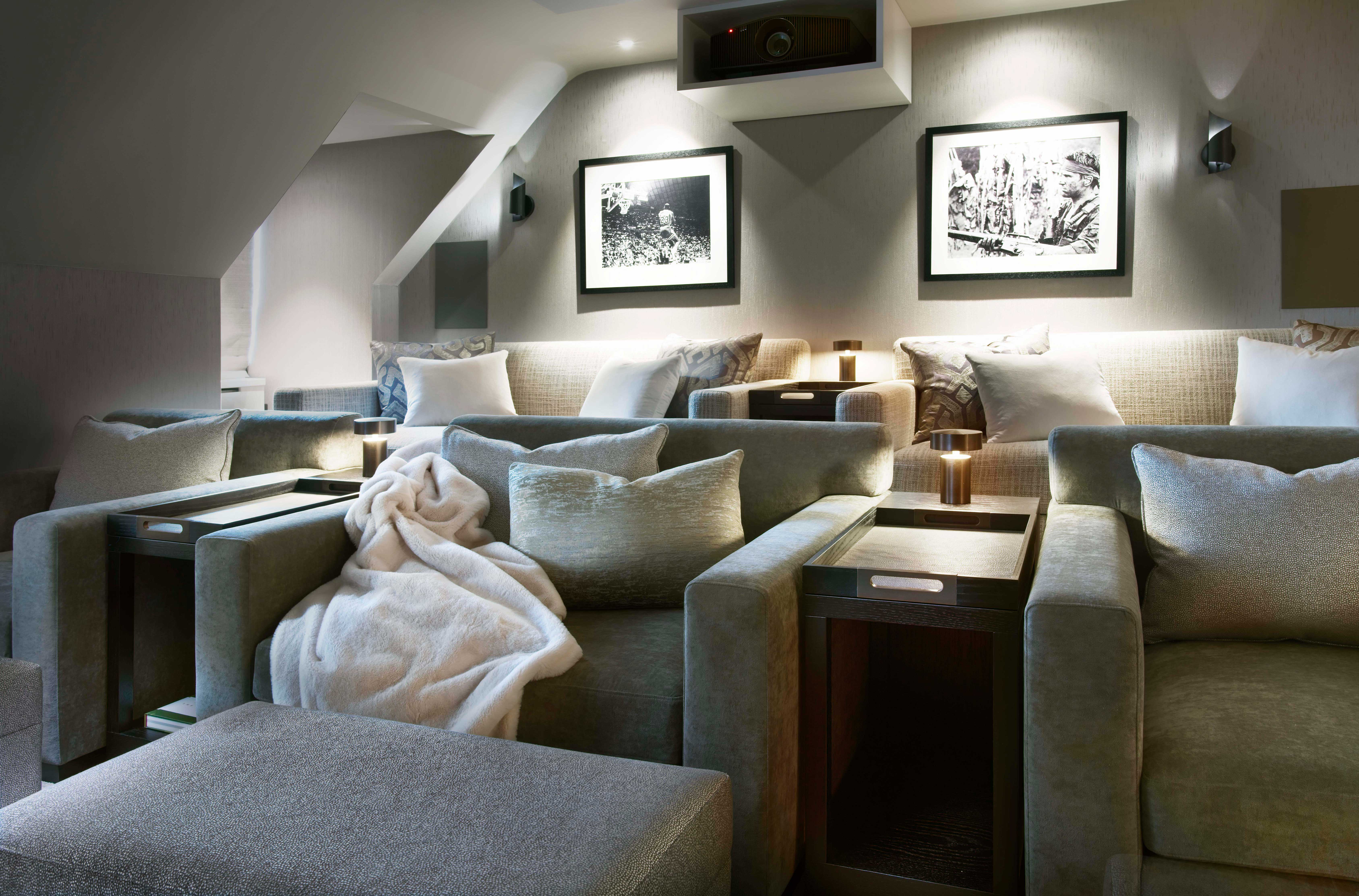 Origins Design crafted two deep-seated sofas, three large armchairs and three ottomans for the cinema seating for a home cinema room designed by Fiona Brass