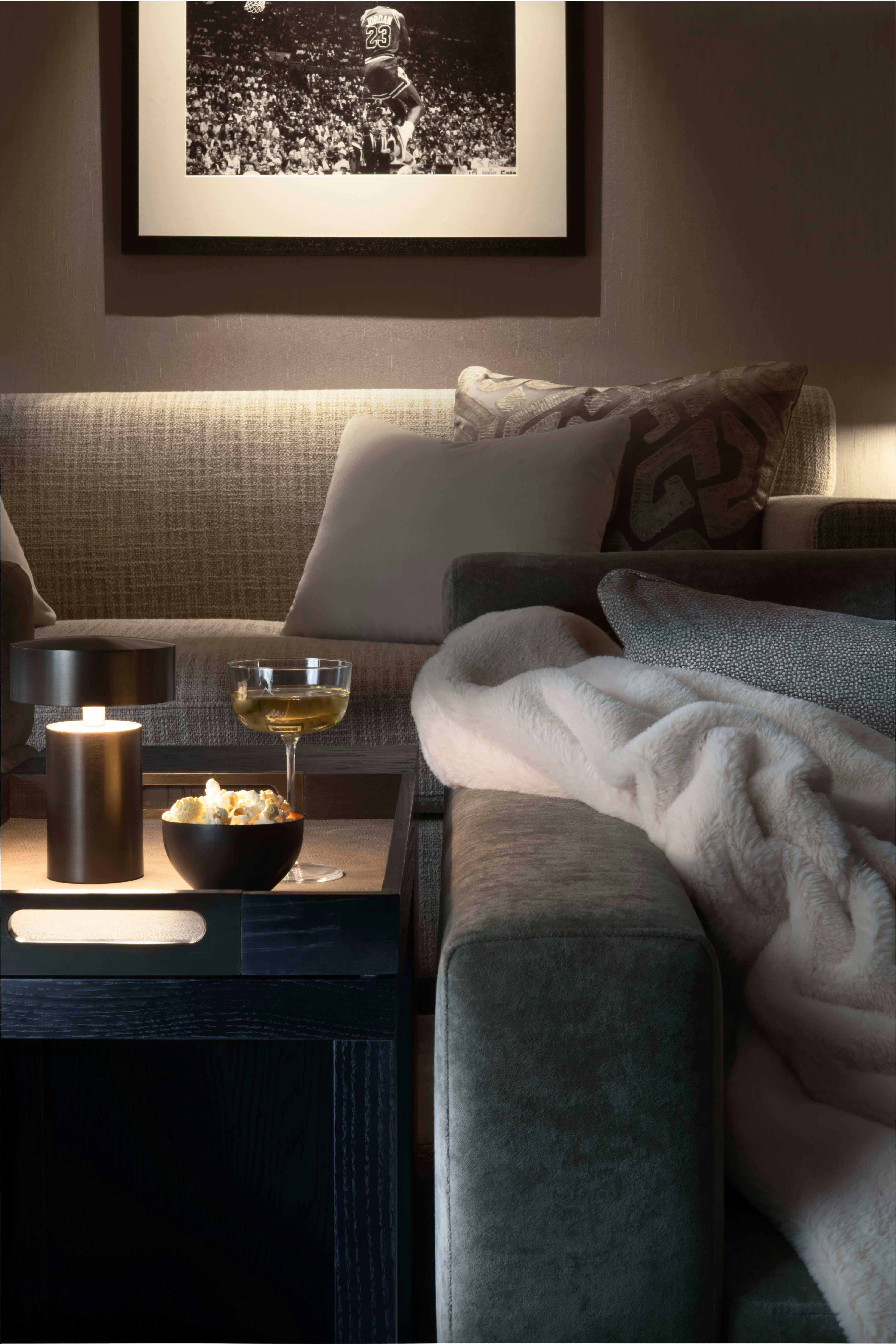 Between the sofas and armchairs, we added side tables fitted with tray tops that could be lifted off to take drinks to and from the home bar - Origins Design