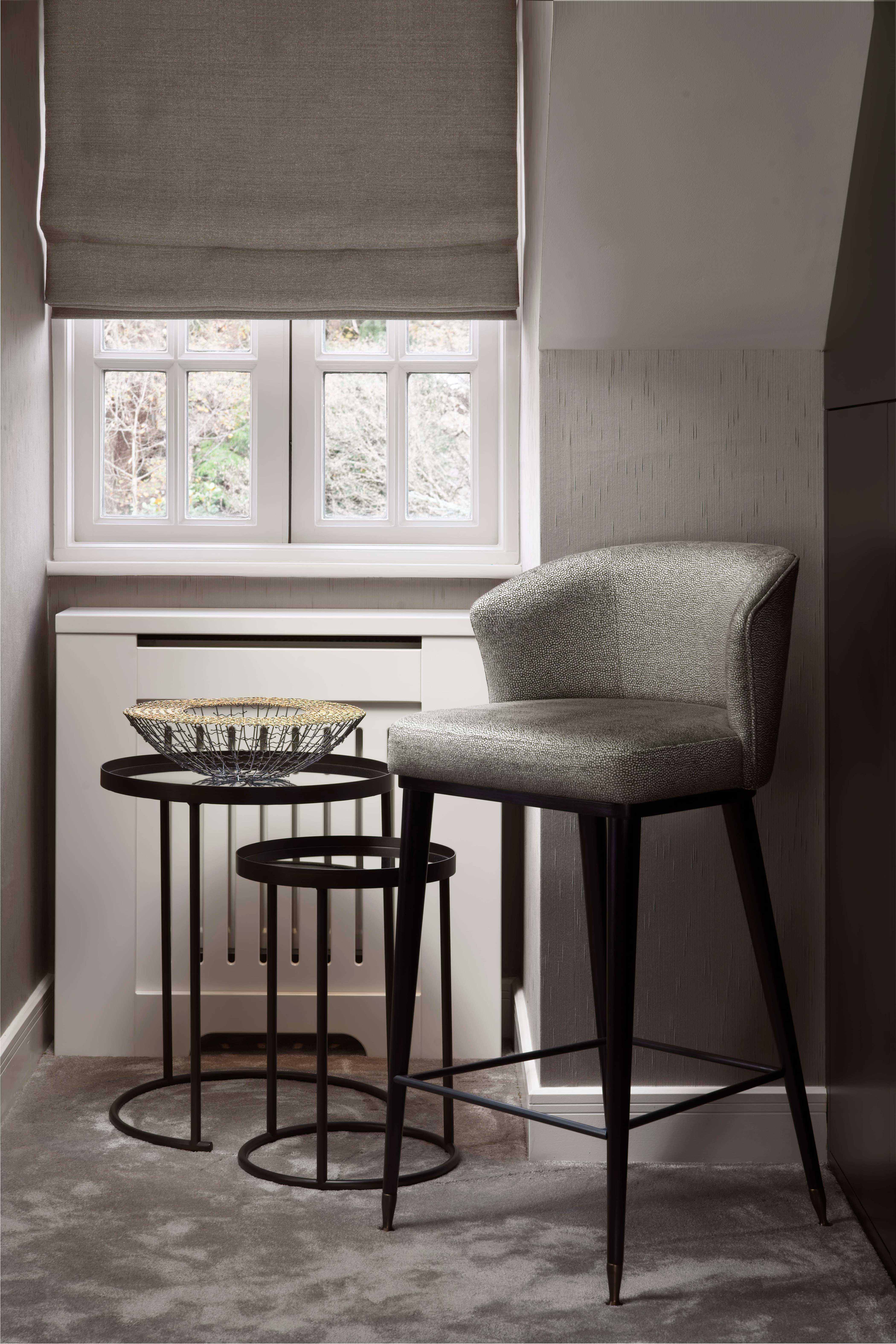 Four bespoke bar stools and two matching occasional chairs by Origins Design sit around the bar and pool table area