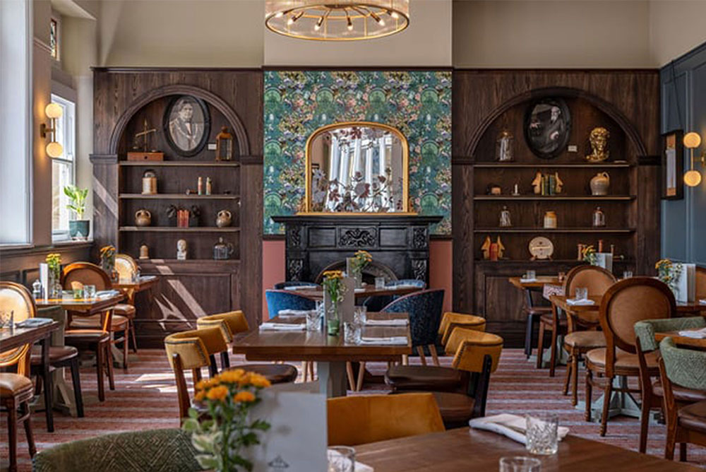 Dining hall with wallpaper chimney breast