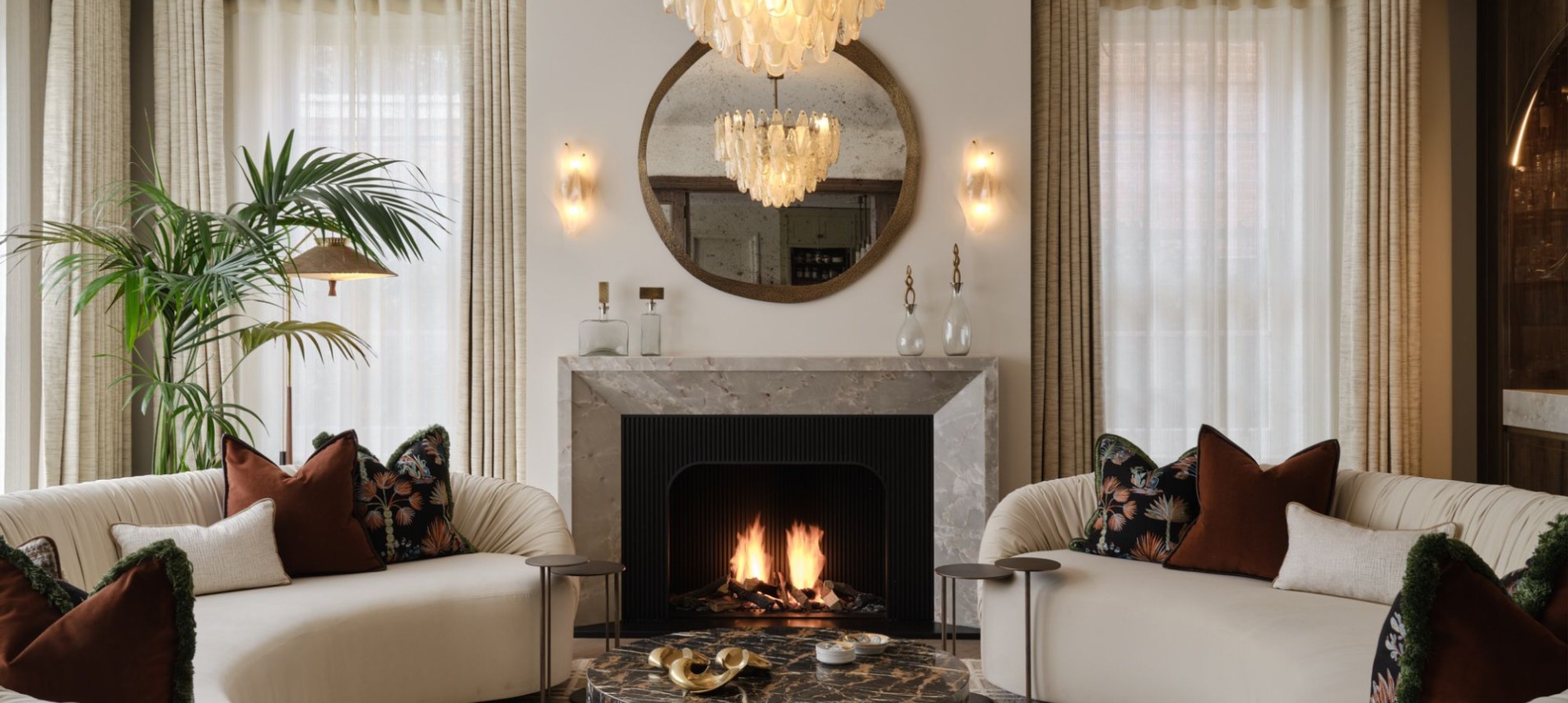 Living room with circular mirror and fireplace