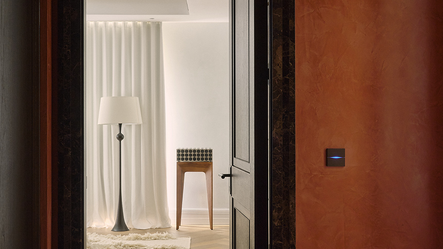 View through a Chelsea Barracks apartment showcasing bespoke floor-length curtains, refined material finishes, and carefully considered architectural details.