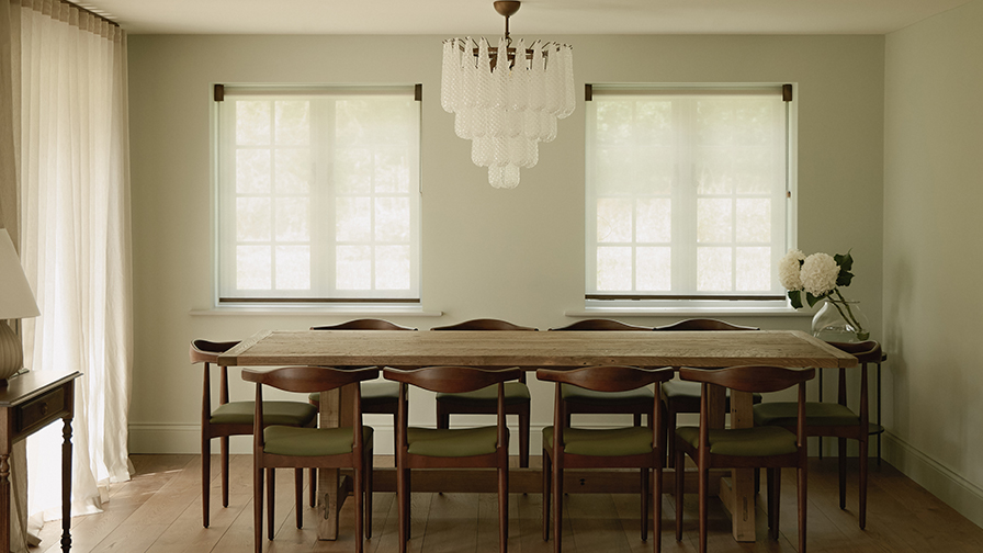 Dining room featuring VENESTRE sheer roller blinds in a heritage Cotswolds farmhouse, softly diffusing natural light while complementing contemporary furnishings and original architectural details.