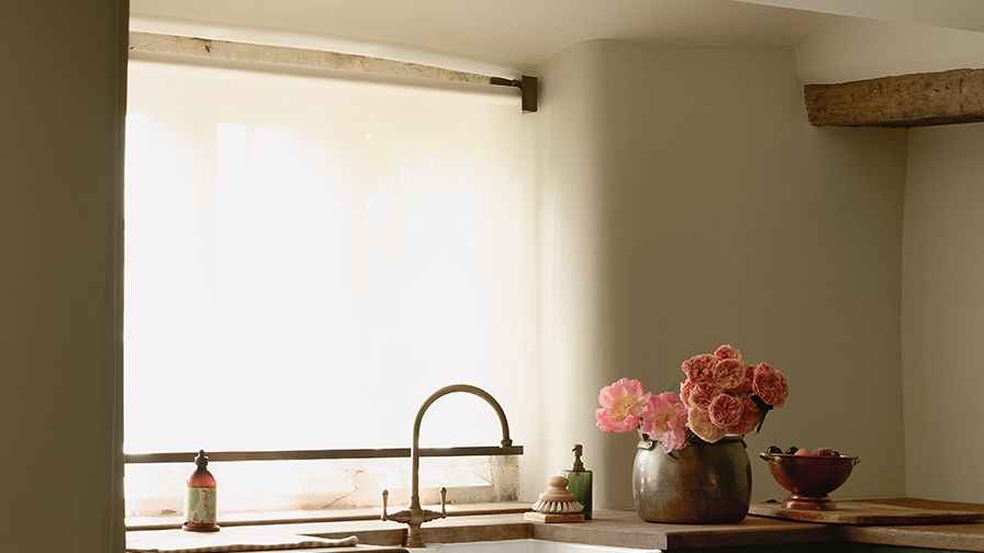 VENESTRE sheer roller blind fitted to a traditional farmhouse kitchen window, providing privacy and filtered daylight while preserving views of the surrounding landscape.