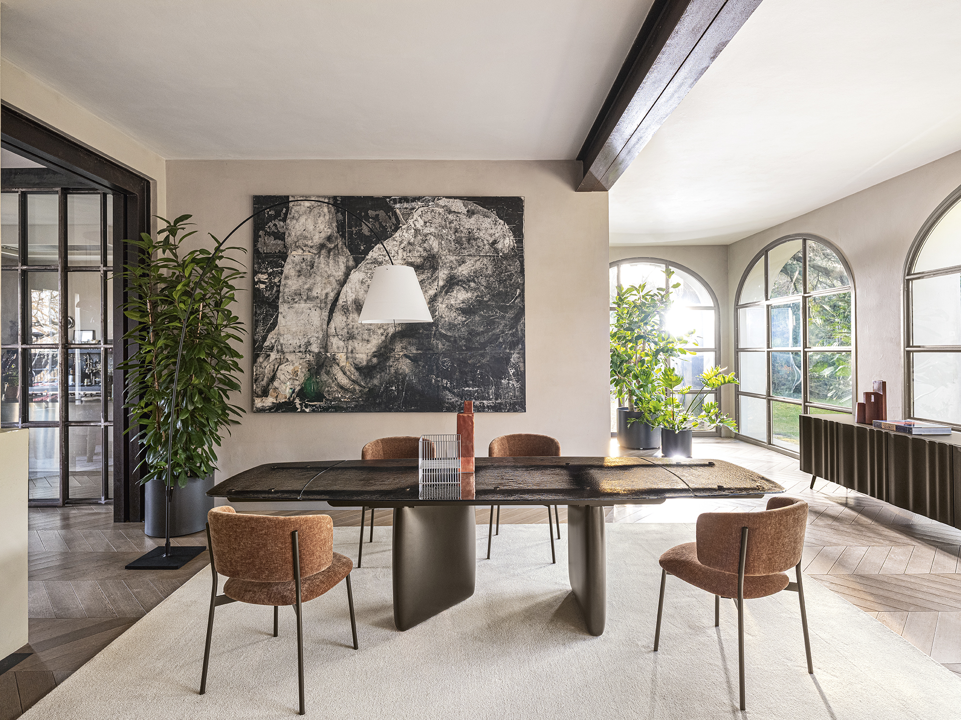 Riverstone originates from the meeting of stability and movement. The asymmetrical bases recall shapes sculpted by water, supporting tops that enhance light and materiality. A table with a sculptural yet harmonious presence, designed to integrate seamlessly into contemporary spaces.