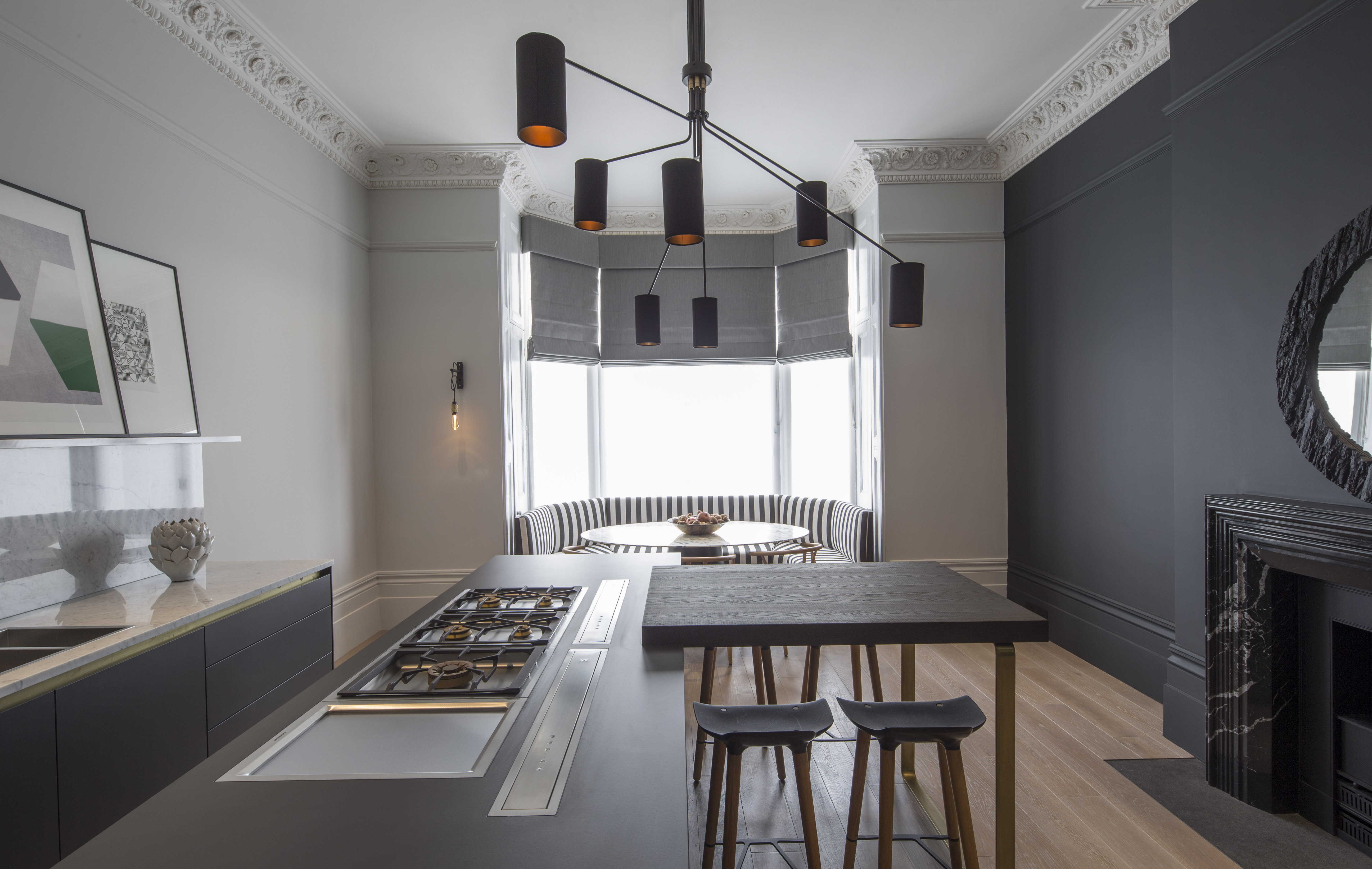 contemporary industrial kitchen with bay window and pendant lighting above kitchen island