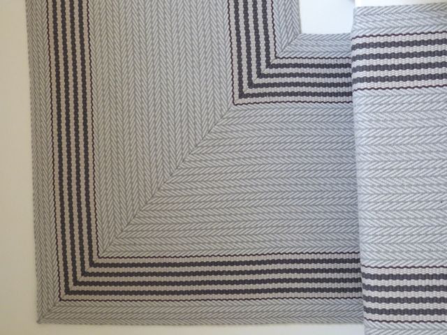 Close detail of Roger Oates striped stair runner with precisely mitred corner on cottage staircase