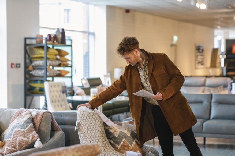 Man studying furniture piece