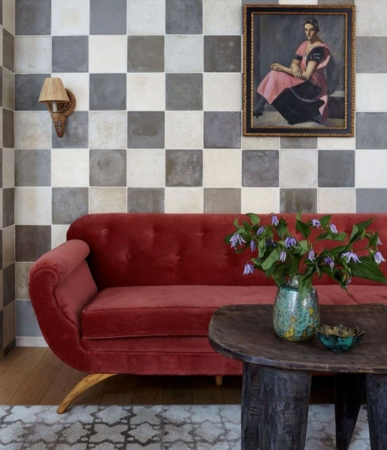 A 1940s sofa sits below a painting by Lora in a SoHoloft designed by Benjamin Vandiver. Photo by Nicole Franzen