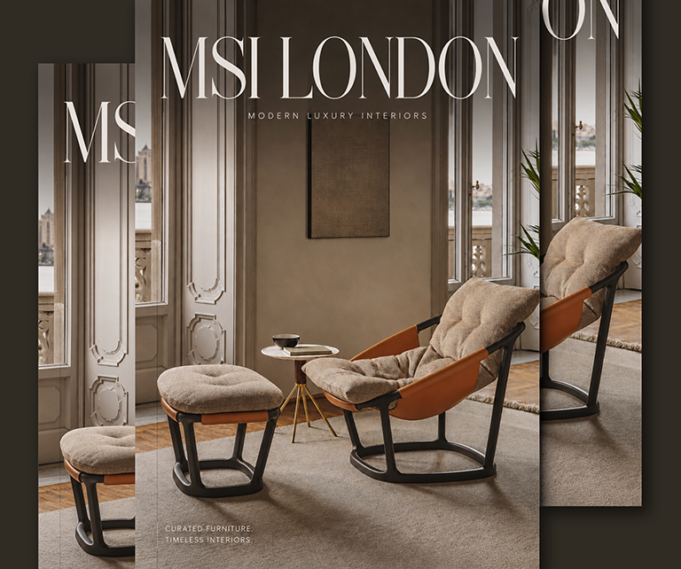 Front of a magazine cover, cream armchair and foot rest by an tall bright window