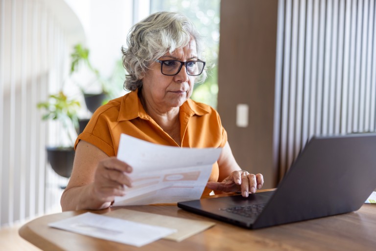 Older lady sitting with paperwork